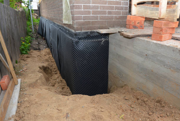 SJ Waterproofing Pros technician performing targeted Emergency Waterproofing assessment in Milroy, IN